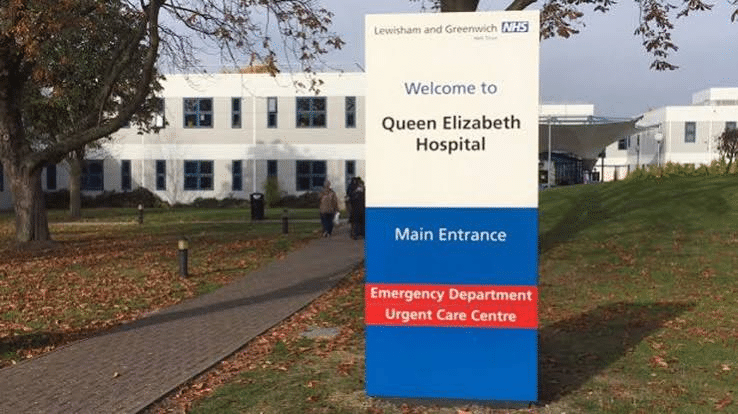 Hospital entrance sign with directions to the main entrance and emergency department